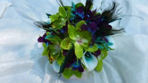 Green orchid, teal picasso calla and galaxy orchid bridal bouquet with peacock