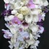 Cascading, calla, tulip, lilac, orchid bridal bouquet with baby's breath, roses