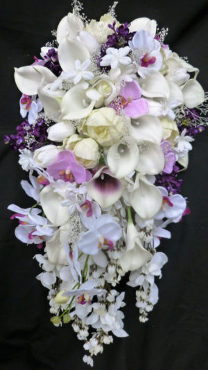 Cascading, calla, tulip, lilac, orchid bridal bouquet with baby's breath, roses