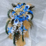 Cascading bridal bouquet with royal blue, gold, champagne flowers, feathers