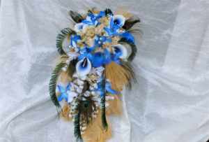 Cascading bridal bouquet with royal blue, gold, champagne flowers, feathers
