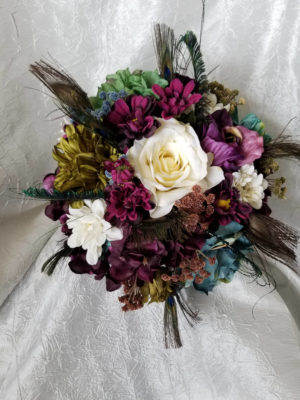 Teal and plum bouquet with peacock feathers