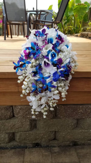 Cascading white hydrangea bouquet with blue orchids