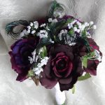 Purple bridal bouquet with peacock accent,  eggplant  and royal purple roses