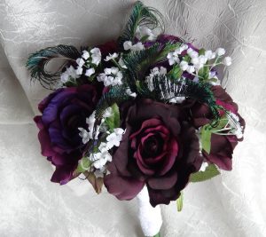 Purple bridal bouquet with peacock accent,  eggplant  and royal purple roses