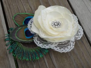 Bridal ivory satin lace flower hair clip accented with a rhinestone, peacock eye and sward feathers