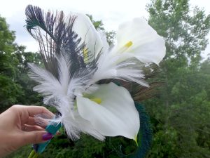 Simple calla lily bridesmaid bouquet with white and peacock feather accent - Image 2