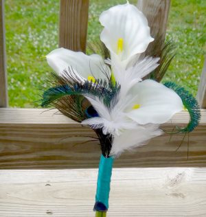 Simple calla lily bridesmaid bouquet with white and peacock feather accent