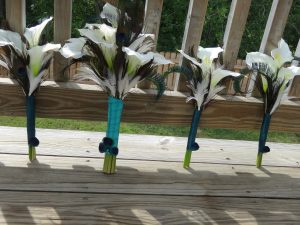 Simple calla lily bridesmaid bouquet with white and peacock feather accent - Image 4