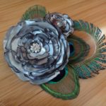 Bridal satin flower hair piece with peacock feathers, available in more colors