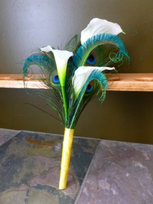Simple calla lily bridesmaid bouquet with peacock feathers - Image 3