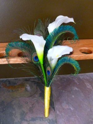 Simple calla lily bridesmaid bouquet with peacock feathers
