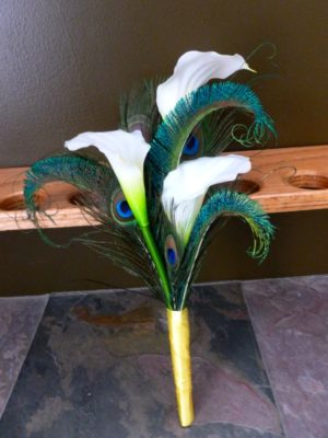 Simple calla lily bridesmaid bouquet with peacock feathers - Image 4