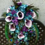 Teal and plum cascading bouquet with peacock feathers