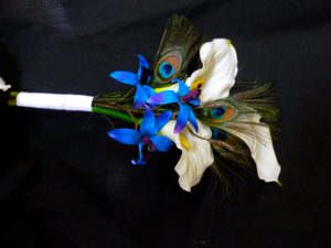 Calla lily and orchid bouquet with peacock feathers