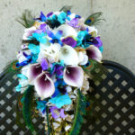 Cascading bridal bouquet with peacock feathers