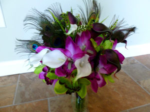 Cymbidium orchid and real touch calla lily bouquet, peacock feathers