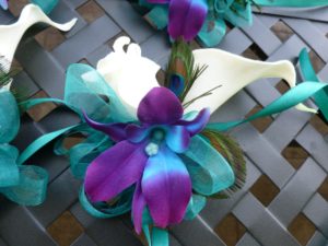 Wrist corsage Galaxy orchid, rose, calla lily, peacock feathers