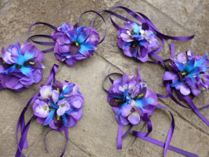 Purple and blue wrist corsage made with purple hydrangeas, galaxy orchids, purple ribbon ties, royal blue, royal purple - Image 2