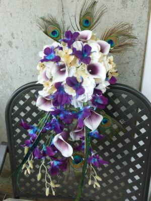 Champagne & plum picasso bouquet with peacock feathers