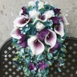 Teal plum cascading bouquet with picasso calla lilies, blue, purple hydrangea bouquet, teardrop bouquet, peacok feathers, pearls